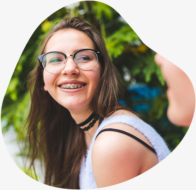 Teen girl with braces smiling outdoors